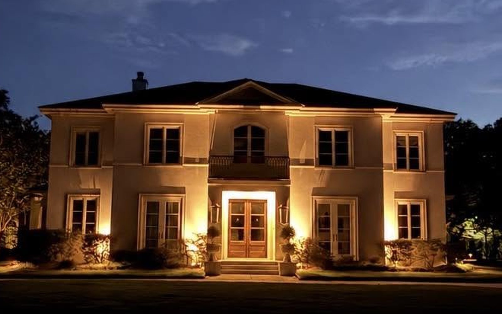 Estate grounds after, lit at dusk